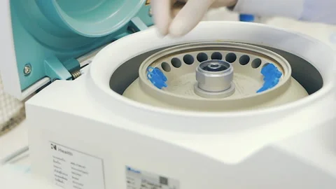 Scientist put solution bottles into centrifuge laboratory Video stock 158528484