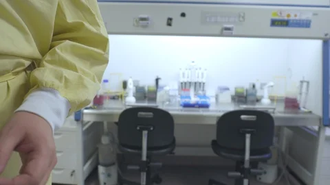 Scientist puts on protective gloves and disinfects his hands with ethanol Stock Footage 129523467