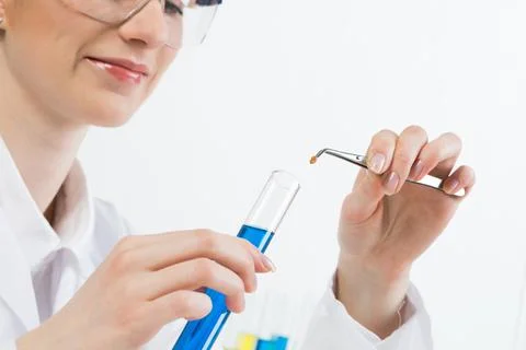 Scientist puts sample into test tube with liquid Stock Photos