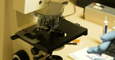 Scientist puts water samples under microscope Vídeos de archivo 114181682