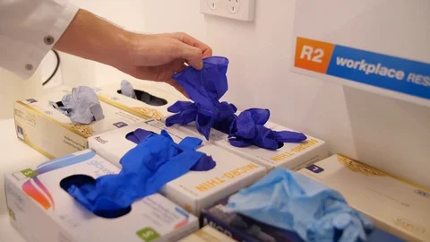 Scientist putting on gloves Stock Footage 127148916