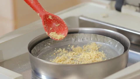 Scientist putting ground wheat in heating machine for analysis 動画素材 273699463