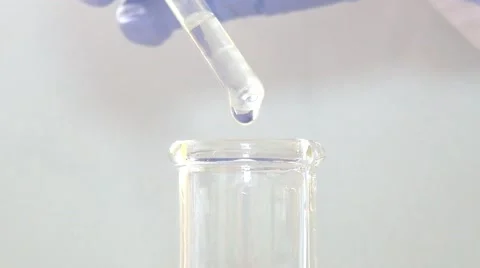 A scientist putting some drops into an Erlenmeyer flask Stock Footage 48985758