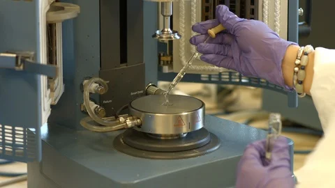 Scientist putting viscous liquid on a microscope plate Stock Footage 106899149