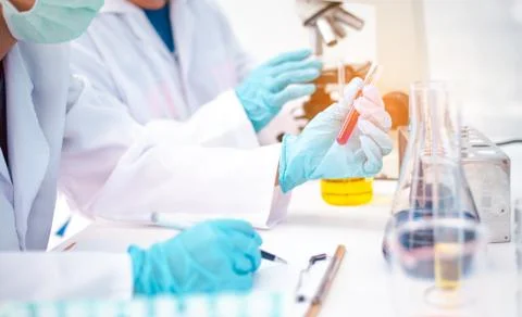The scientist is recording the scientific value on a note. In an experiment i Stock Photos