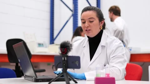 Scientist recording video tutorial in laboratory Stock Footage 255196448
