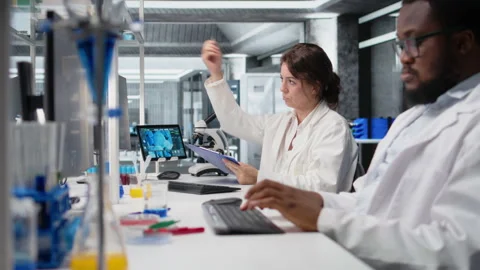 Scientist records observations in lab, doing validation of clinical results Stock Footage 320728538