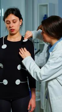 Scientist researcher preparing woman patient for endurance test Stock Photos
