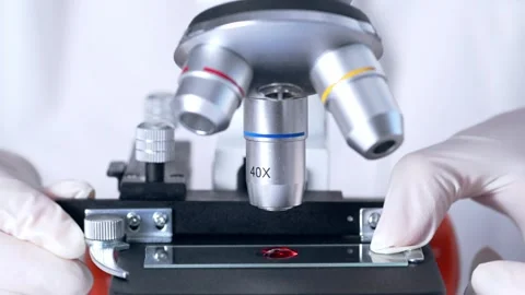 Scientist researching blood sample under microscope in laboratory.  Stock Footage 270758687