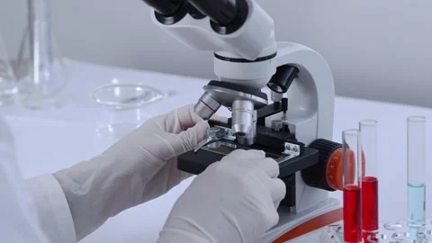 Scientist researching blood sample under microscope in laboratory. Video stock 273578400