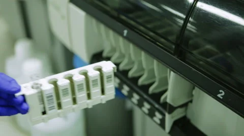 Scientist in Rubber Gloves Puts a Tray With Samples For Analysis in the Machine Stock Footage 61006577