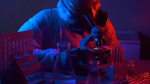 Scientist in scientific laboratory looking into microscope. Stock-Footage 123975734