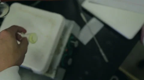 Scientist shaking beaker over hot plate. Video stock 37988532