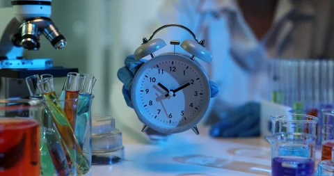 Scientist shows alarm clock setting start time for research Stock Footage 277391080