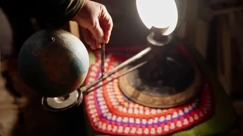 Scientist slowly rotating small globe on a tellurium, an educational model used Stock Footage 297610930