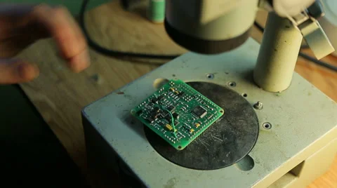 Scientist solder, looking through a microscope Stock Footage 42820906