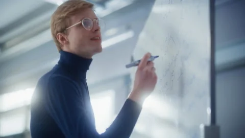 Scientist Solving Problems Using Whiteboard Stock Footage 189869249