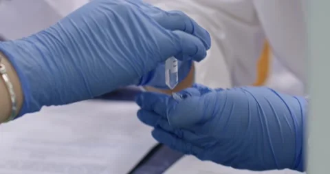 Scientist sorts through small Eppendorf test tubes Stock-Footage 341567814