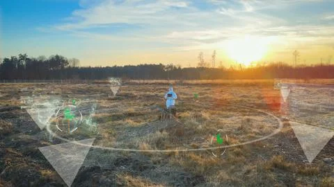 Scientist standing on desolate land analyse with 5G device a contaminated land Foto stock