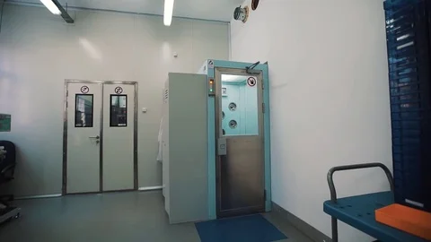 Scientist in sterile clothes walks into disinfection chamber and fooling around Stock Footage