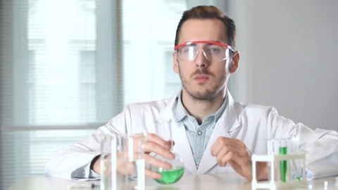 Scientist stirs the liquid in the flask and inhales the aroma Stock-Footage 73111138