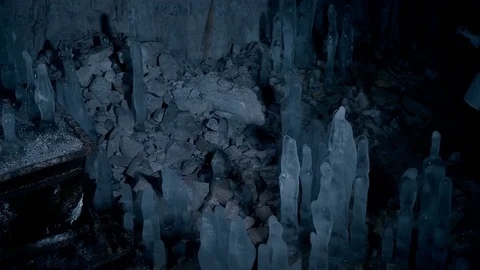 A scientist studying ice stalagmites in the cave Stock Footage 73073942