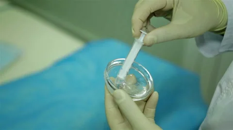 Scientist with a syringe and substance Stock Footage 65291573