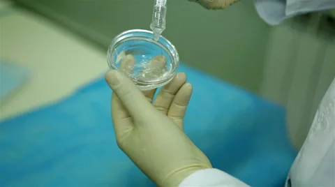Scientist with a syringe and substance Stock Footage 65302963