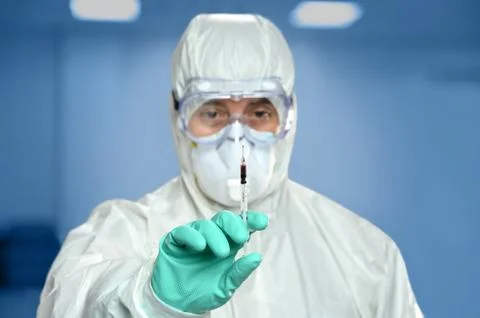 Scientist With Syringe containing Blood Foto stock