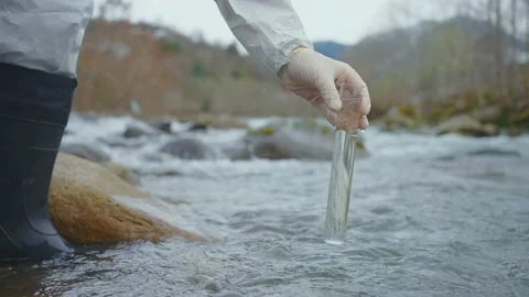 Scientist takes samples dirty water test,Explorers work test tube close up Stock Footage 234387995