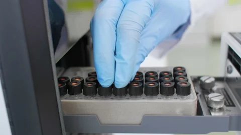 Scientist taking cbd samples from chromatography machine in laboratory Stock Footage
