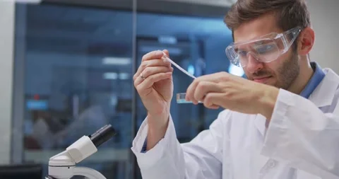 Scientist taking samples from tubes in the laboratory, uses Petri dish. Doctor Stock Footage 144808003