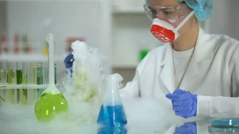 Scientist taking yellow liquid sample in pipette and checking sediment, petrol Stock Footage 103367702