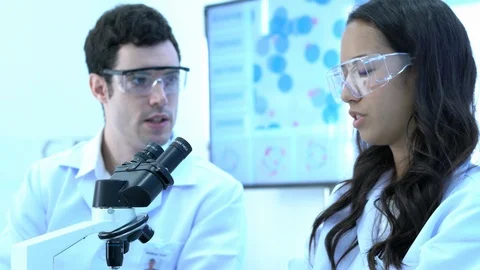 Scientist is talking with colleagues working in modern laboratory. Stock-Footage 106869837