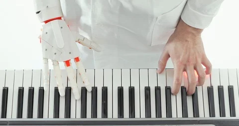 Scientist is tasting robotic prosthesis hand playing the piano trying to press Stock Footage 106221188