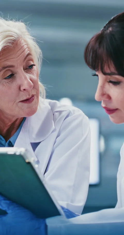 Scientist, team and feedback with tablet at laboratory with talk, discussion and Stock Footage 331347651