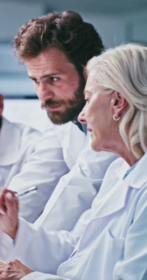 Scientist, team and people with computer in lab, medical research and talk with Stock Footage 331350672