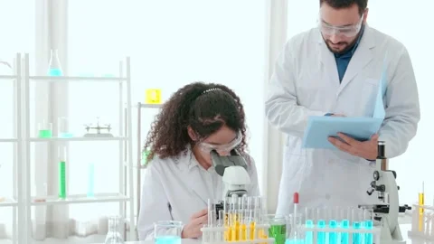 Scientist team use microscope in the lab. Biotechnology researcher scienti Stock Footage 205497465