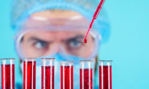 Scientist with test tubes making research. Laboratory technician with blood s Stock Photos