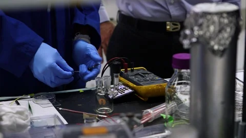 Scientist testing a device with digital multimeter in lab Stock Footage 93515803