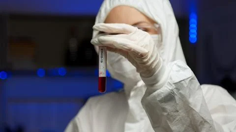 Scientist testing sample for COVID-19 in tube Stock Photos