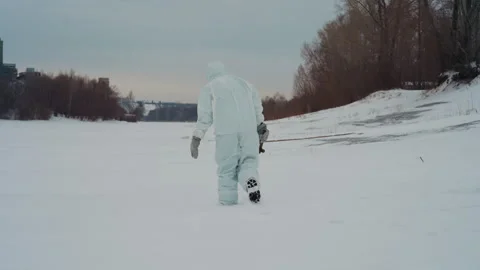 Scientist traverses icy coast. Explorer equipped with radiation detector walks 動画素材 342743748