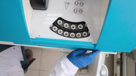 The scientist turns on the device. Centrifuge with test tubes. Laboratory Stock Footage 231740480