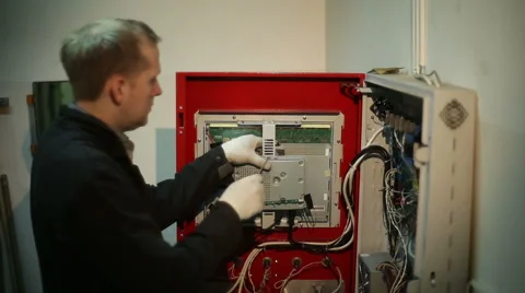 The scientist twists the screws using screwdriver in the switchboard Stock Footage 59596601