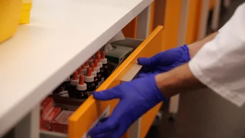 Scientist Unpacking a draw and setting up bench Stock Footage 127149067