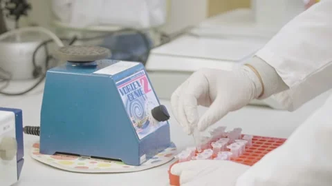 Scientist use blue vortex mixer for test tubes in laboratory Stock Footage 169945333