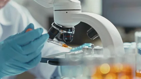 A scientist uses an electron microscope to examine the details of a virus. 스톡 동영상 336582711