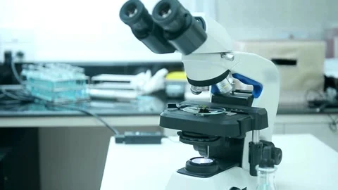 A scientist uses an electron microscope to examine the details of a virus. 스톡 동영상 336582731