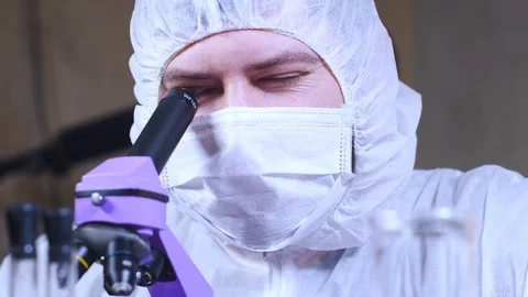 Scientist uses a microscope for scientific research. Researcher in laboratory. Stock-Footage 122763963