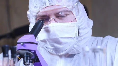 Scientist uses a microscope for scientific research. Researcher in laboratory. Stock Footage 122764137
